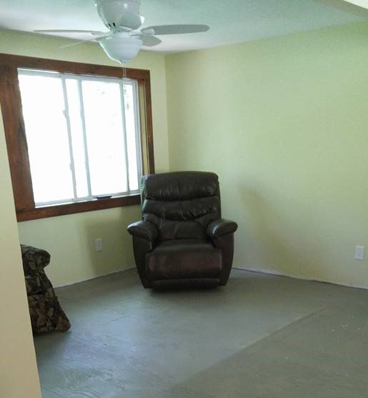 Recliner in an empty room with no flooring